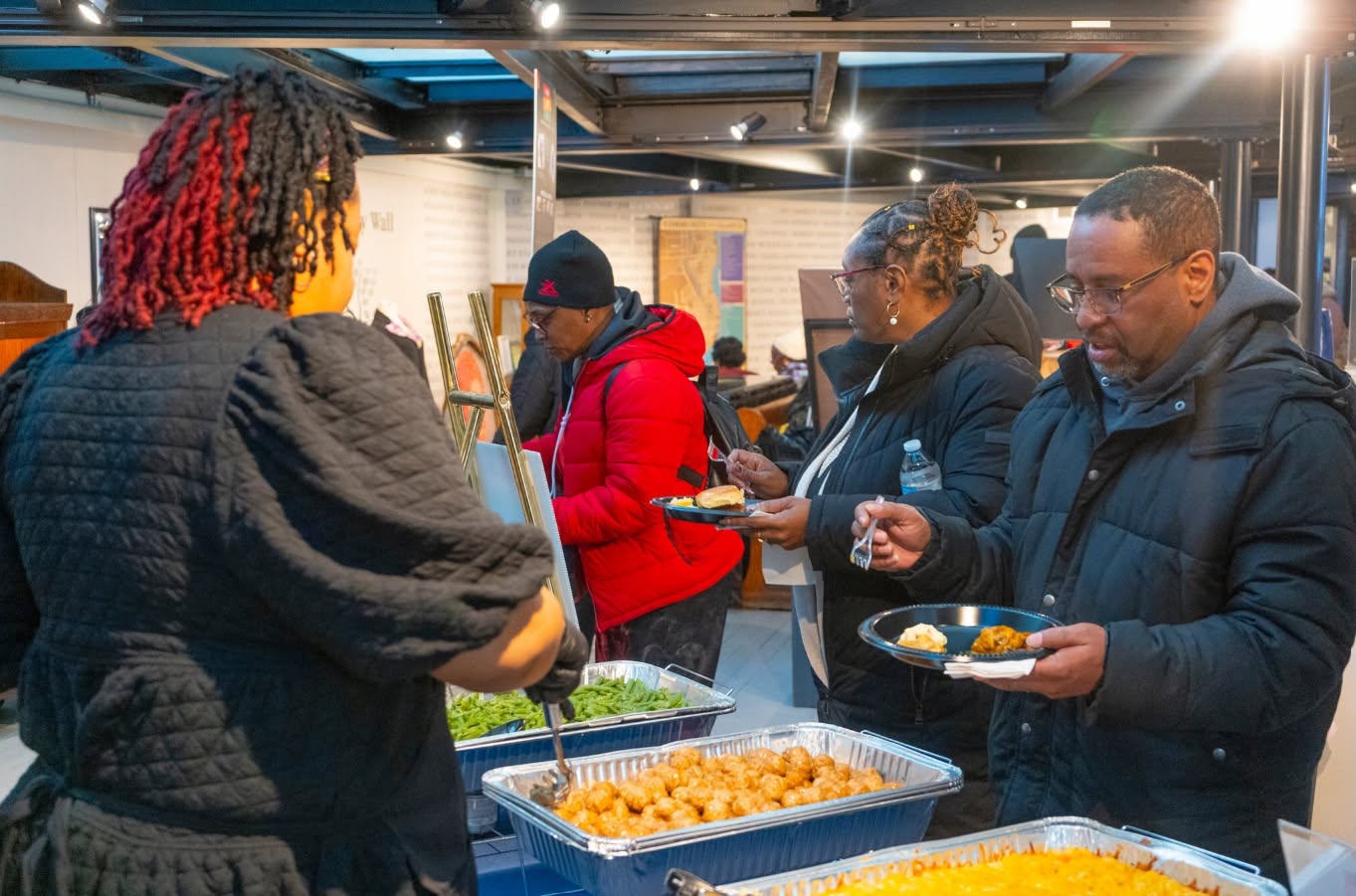 Guests served at a buffet line during a community gathering