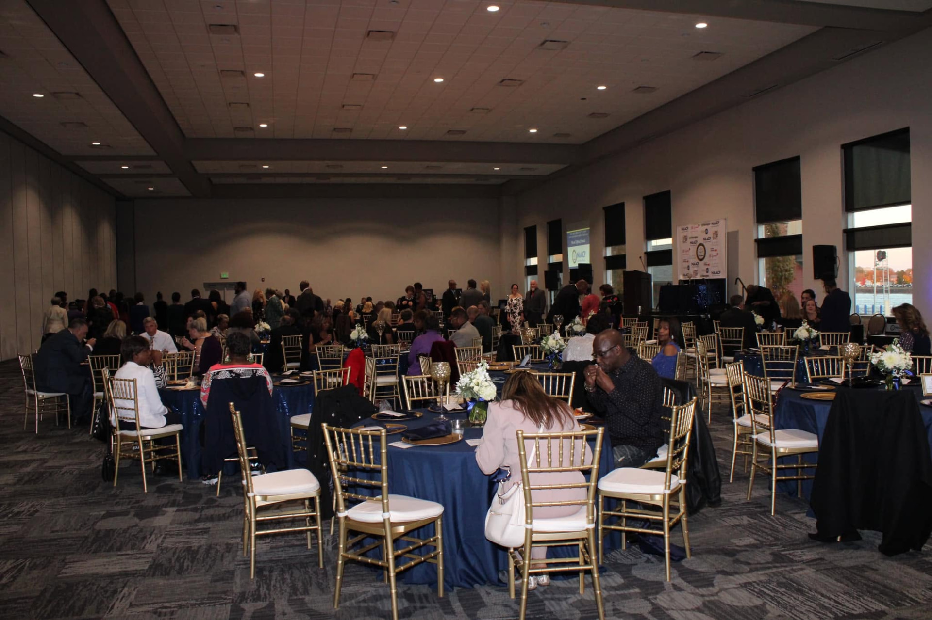 Guests gathered at round tables for a large-scale gala